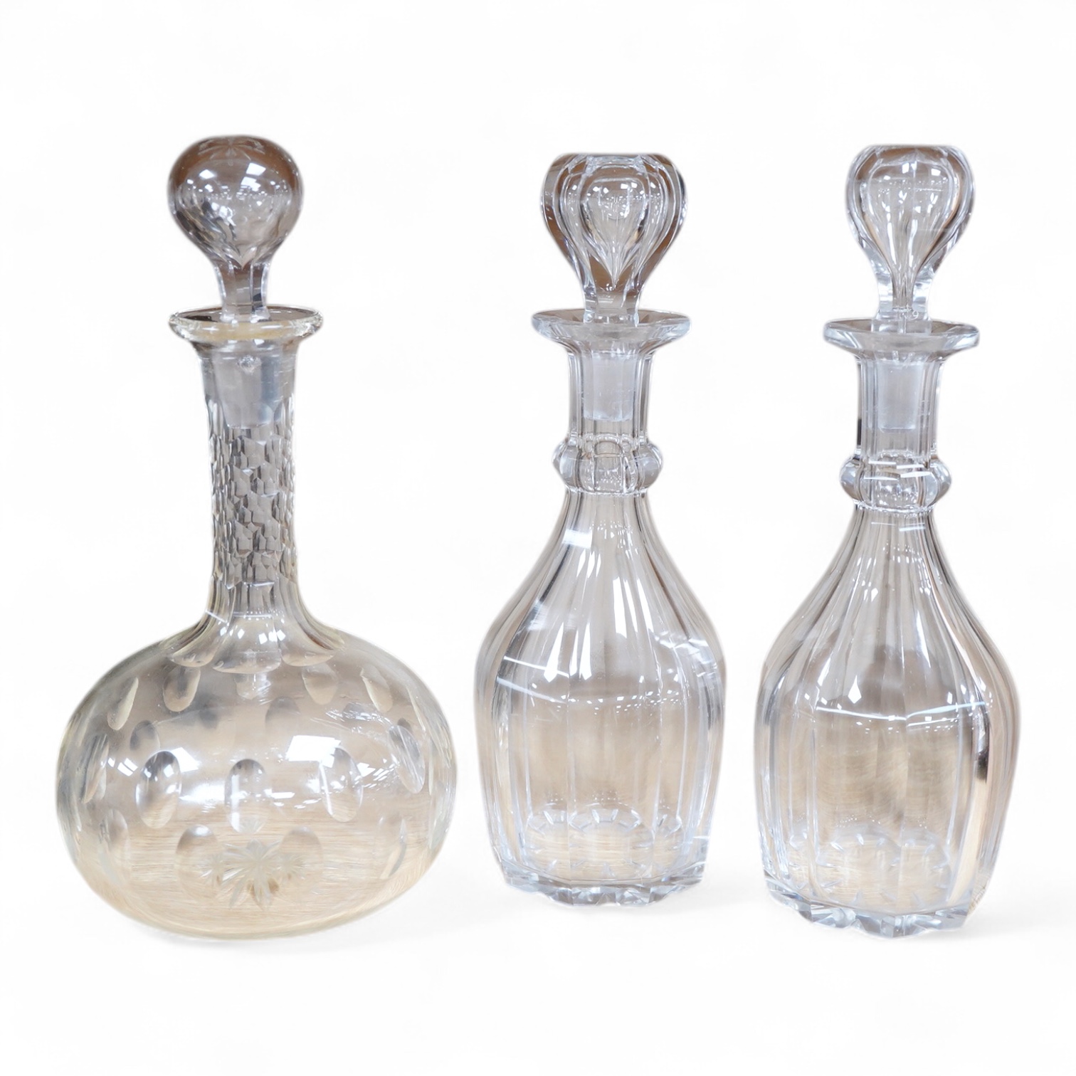 A pair small cut glass decanters and stoppers - 27cm high and a larger similar single decanter and stopper